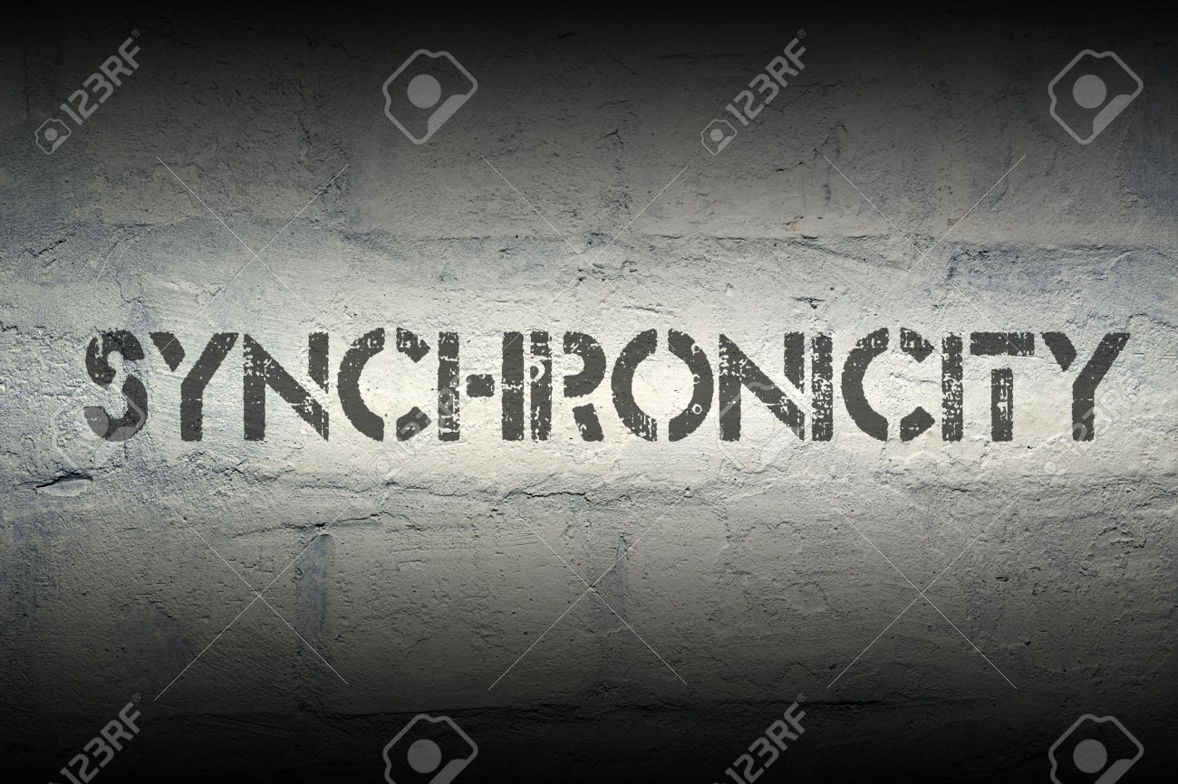 synchronicity stencil print on the grunge white brick wall